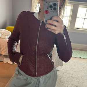 Maroon leather jacket with zippers on sleeves